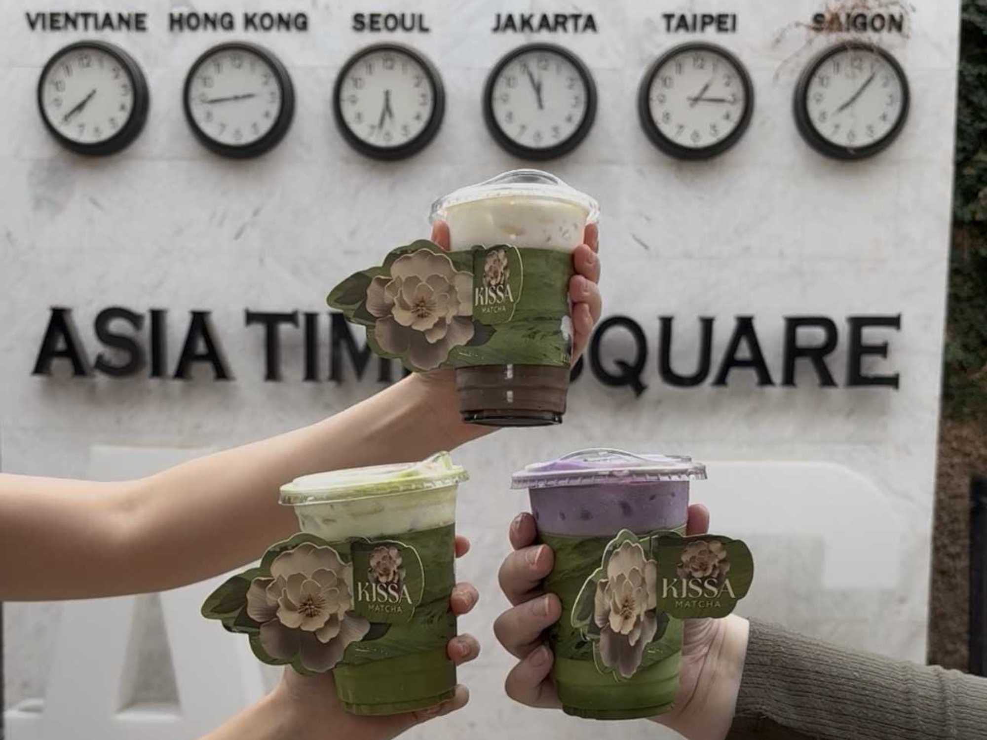 An assortment of iced matcha specialty drinks from Kissa Matcha, served in custom floral cup sleeves.