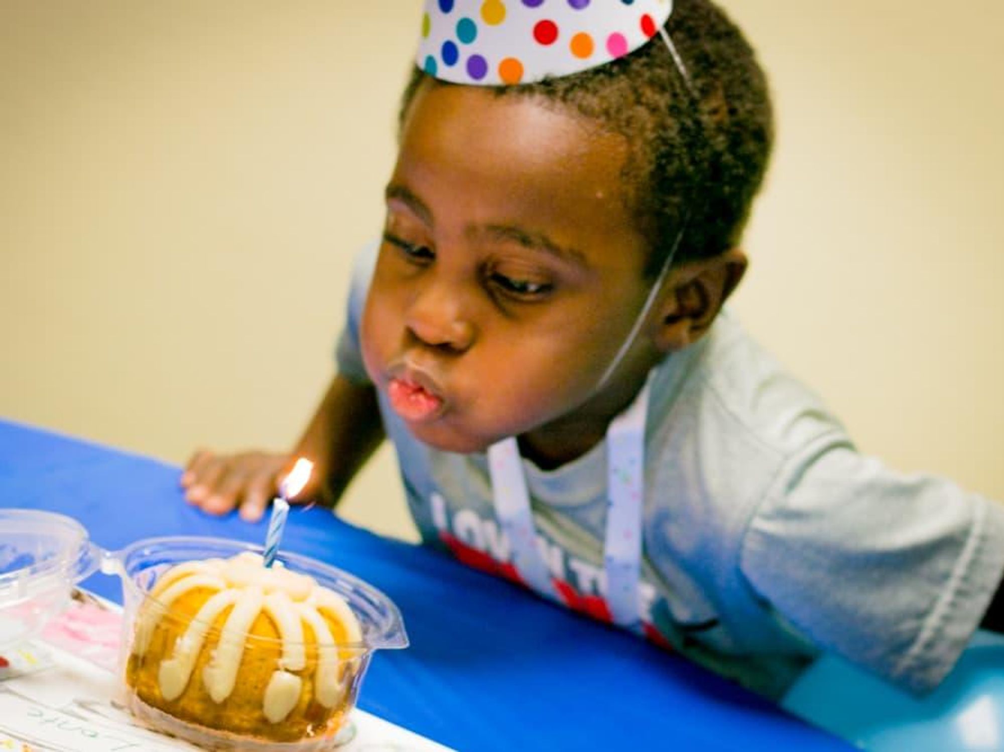 Boy blowing out candle courtesy of Dallas' Birthday Party Project