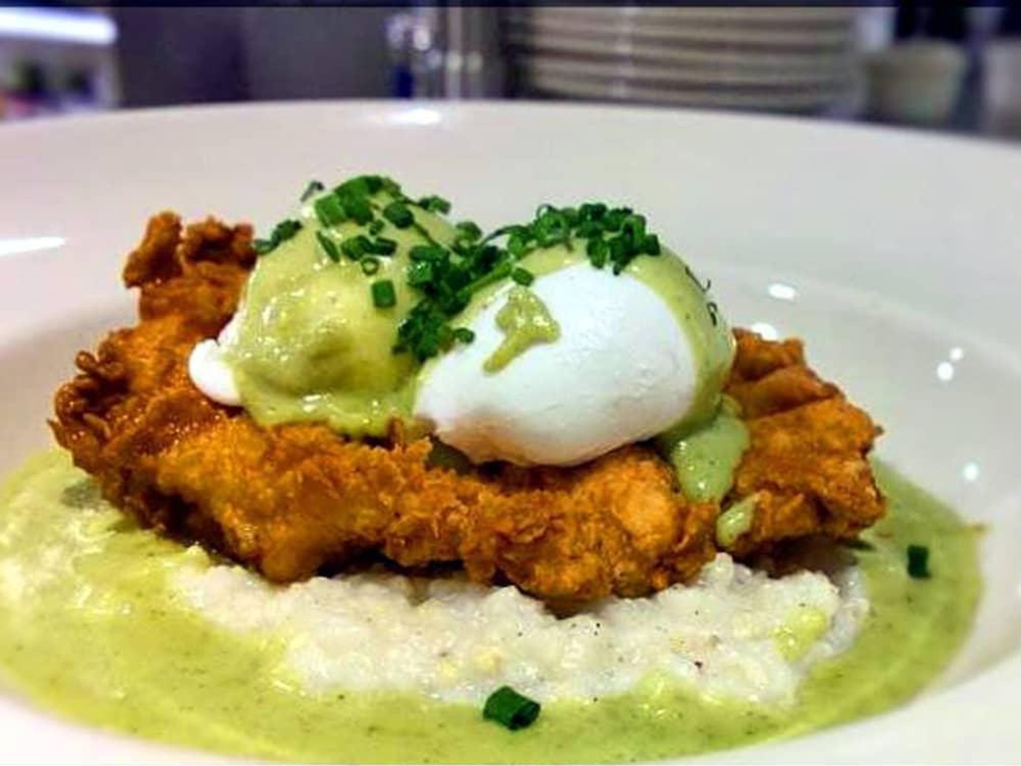 Buttermilk fried chicken with pepperjack grits, jalapeno gravy and poached eggs at Bird Cafe