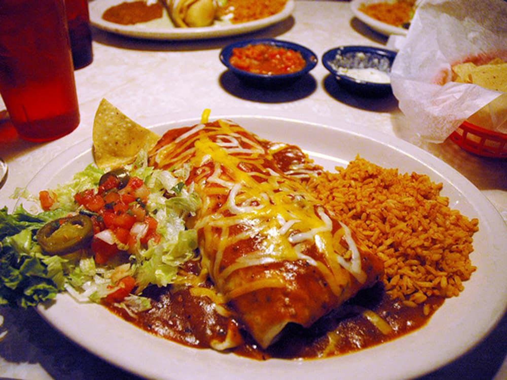 Chuy's giant burrito with cheese on top