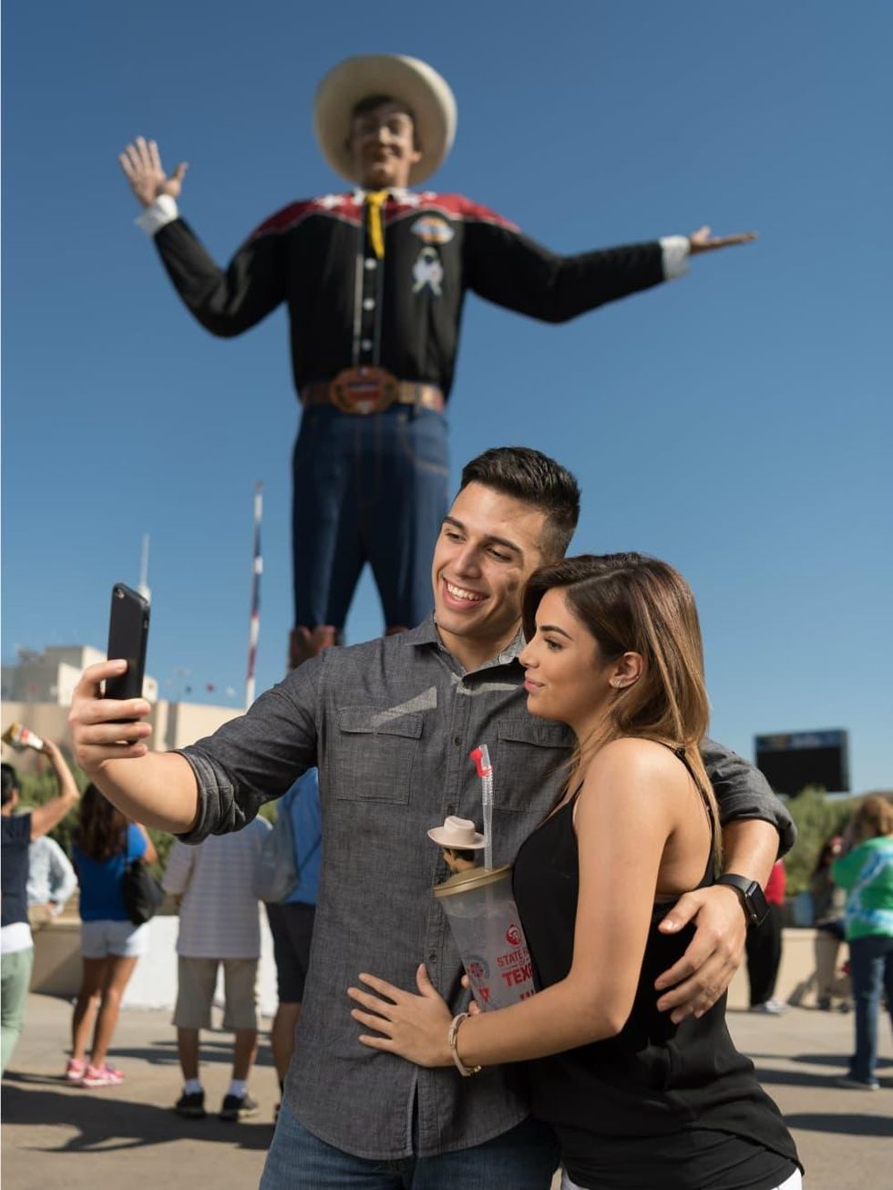 Couple taking a selfie with Big Tex