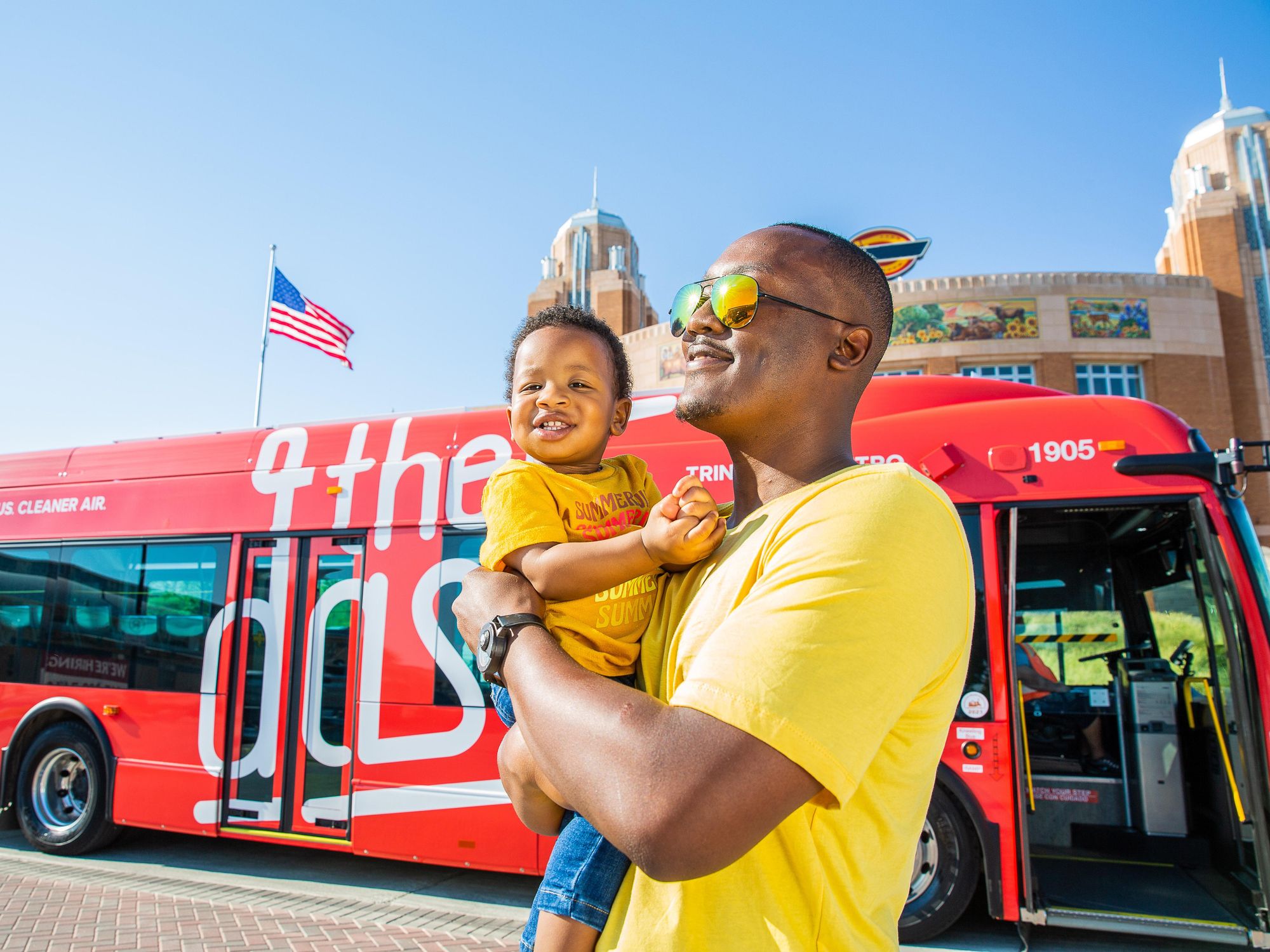 Father and son in front of The Dash bus