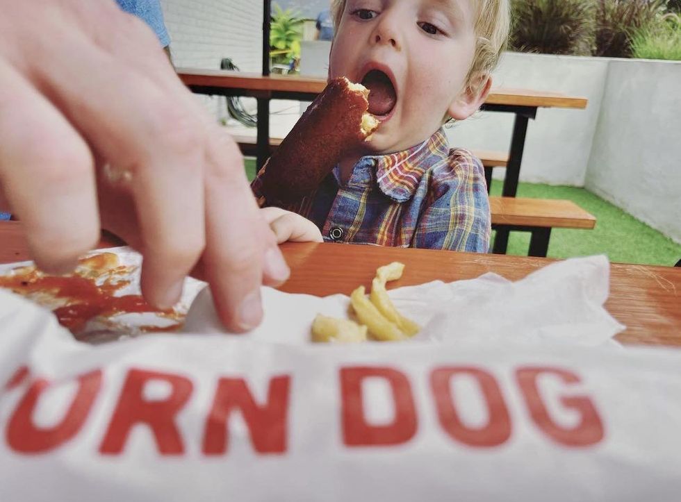 Kid eating corndog in Boerne