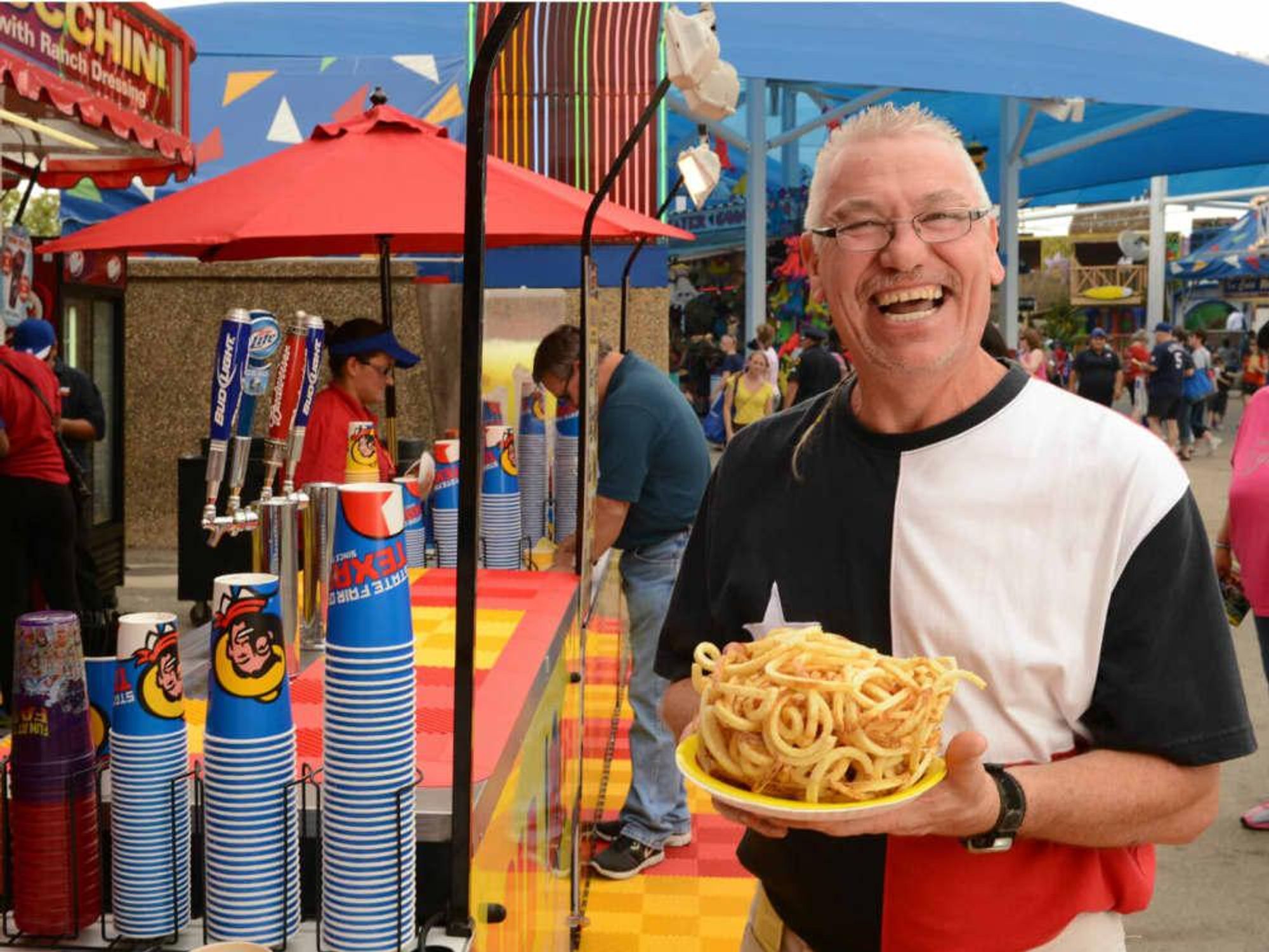 Man eating french fries at State Fair of Texas