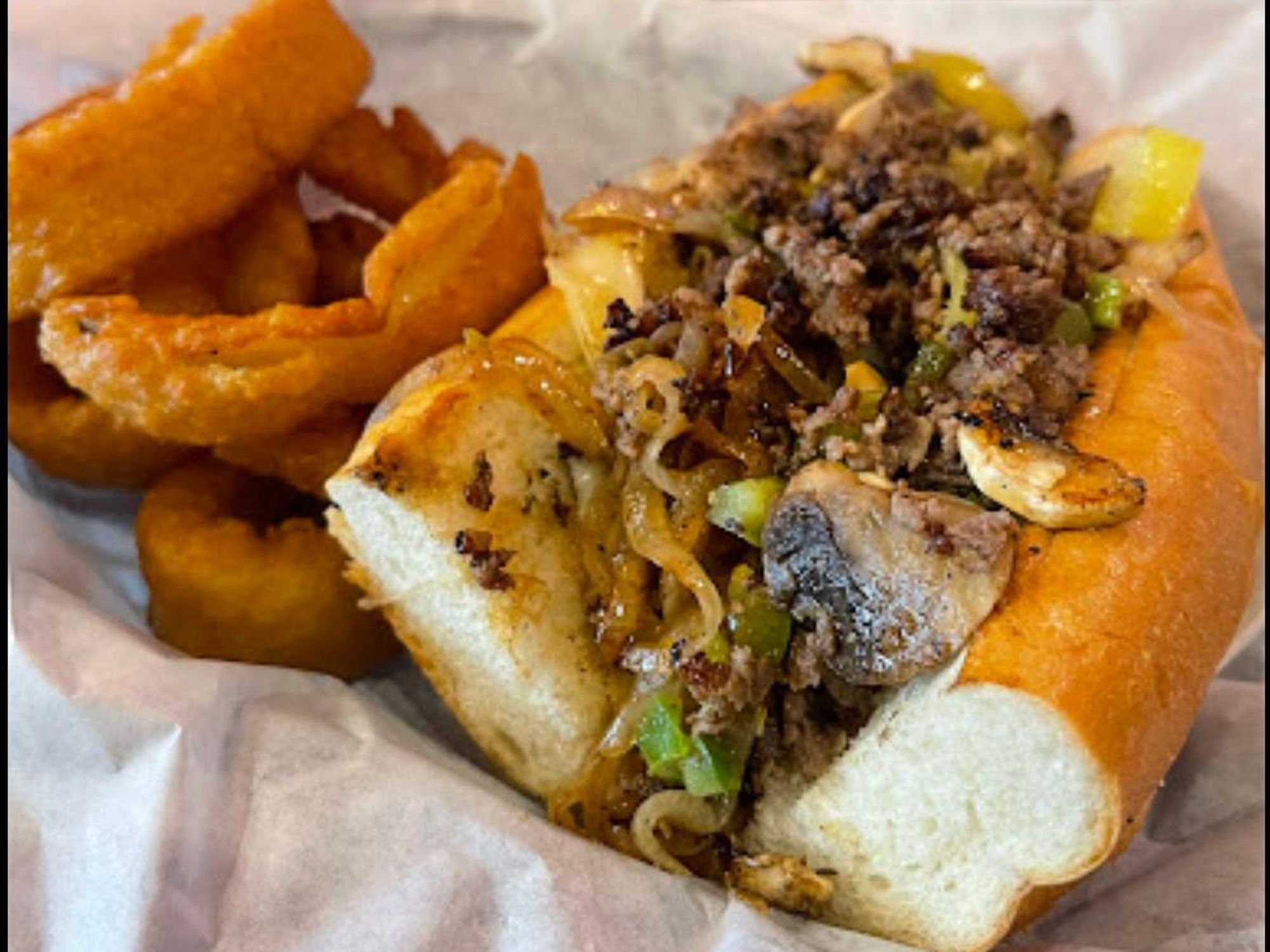 Philly Dave's cheesesteak and onion rings