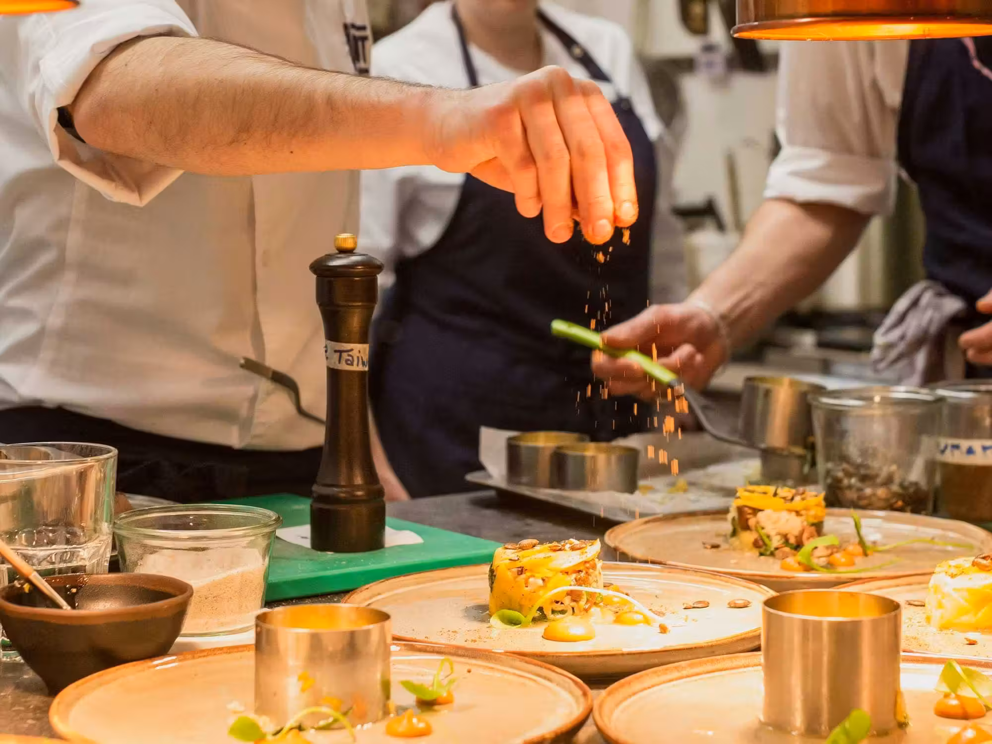 Restaurant chef garnishing signature dishes