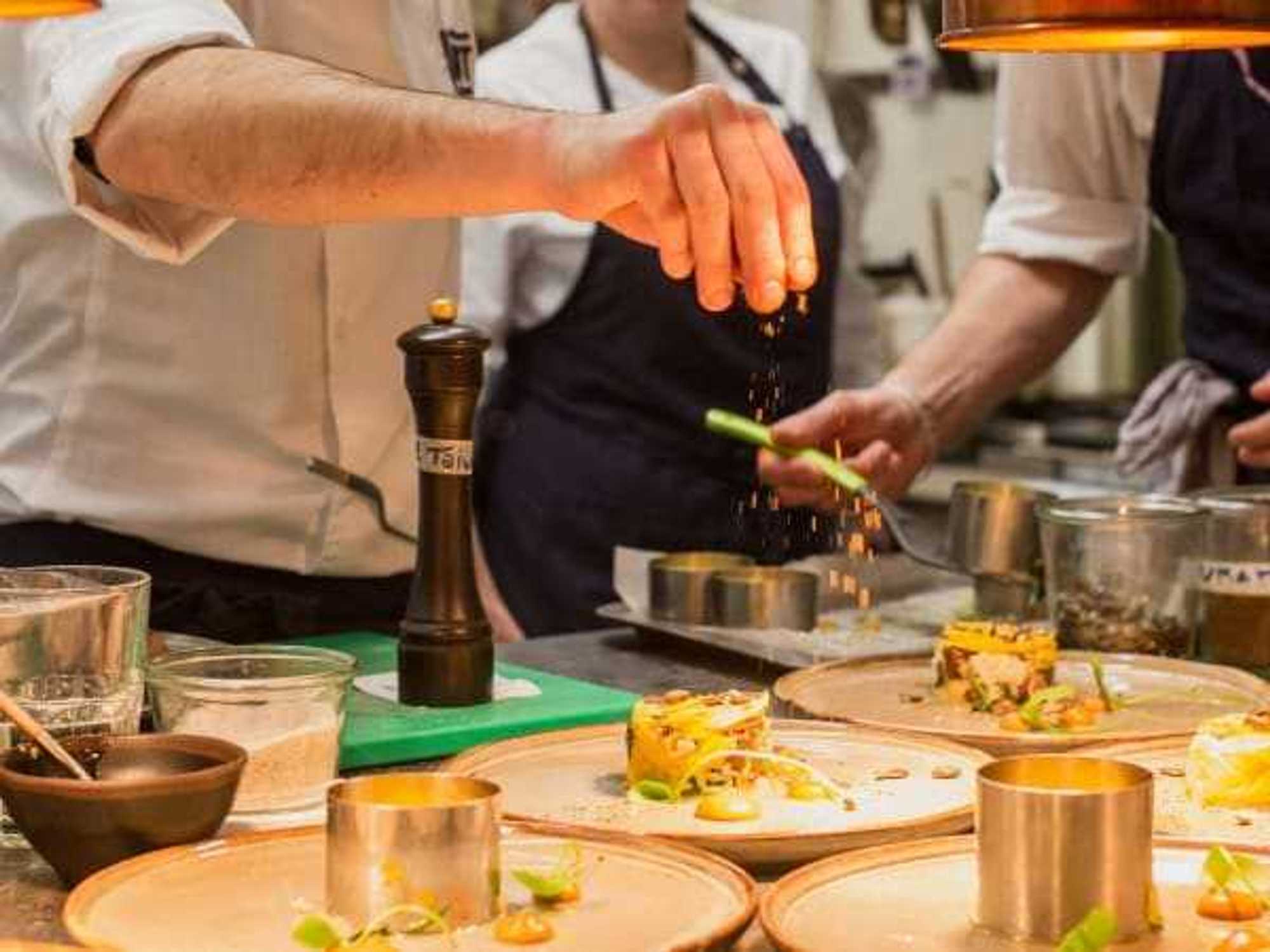 Restaurant chef garnishing signature dishes