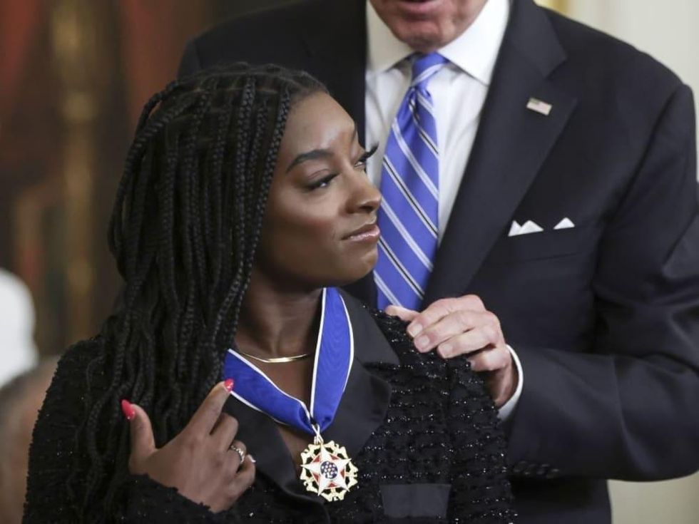 Simone Biles receives the prestigious medal from President Joe Biden at