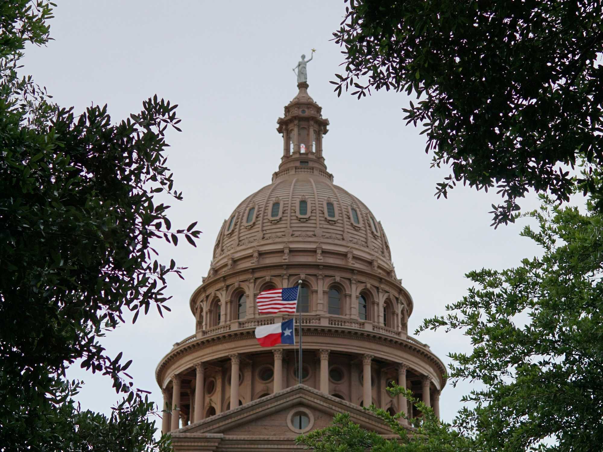 Texas Capitol building with state and US flags