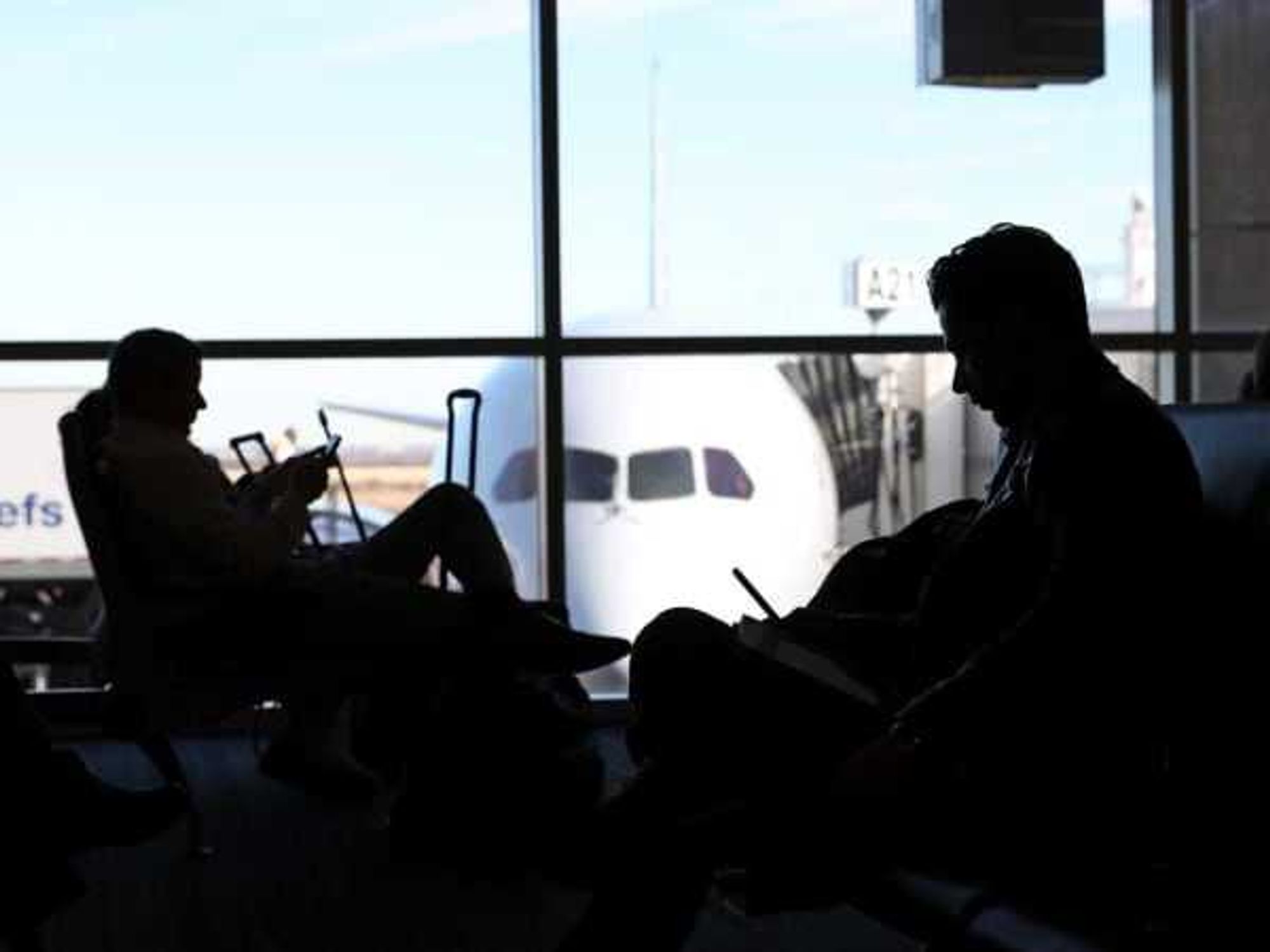 Travelers waiting for their flights at Dallas/Fort Worth International Airport