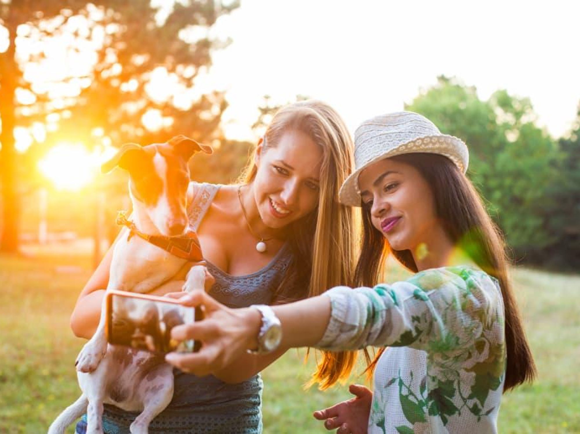 Two girls with dog park selfie